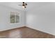 This bedroom boasts a ceiling fan and a light-filled window with shade at 1405 E Chicago Cir, Chandler, AZ 85225