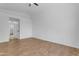 A bright bedroom features a ceiling fan, neutral walls, and wood-look floors at 1405 E Chicago Cir, Chandler, AZ 85225