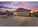 Exterior of single-Gathering home with a two-car garage and desert landscaping at 1405 E Chicago Cir, Chandler, AZ 85225