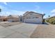 Exterior of single-Gathering home with a two-car garage and desert landscaping at 1405 E Chicago Cir, Chandler, AZ 85225