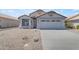 Exterior of single-Gathering home with a two-car garage and desert landscaping at 1405 E Chicago Cir, Chandler, AZ 85225
