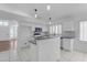 Bright kitchen with white cabinets, stone countertops, and stainless steel appliances at 1405 E Chicago Cir, Chandler, AZ 85225