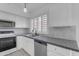 Bright kitchen features stone countertops, tile backsplash, stainless steel appliances at 1405 E Chicago Cir, Chandler, AZ 85225