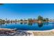 Picturesque lake view showcasing waterfront houses, lush foliage and clear blue skies at 1405 E Chicago Cir, Chandler, AZ 85225