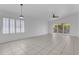 Bright living room featuring tile floors, shutters, and sliding glass doors to the backyard at 1405 E Chicago Cir, Chandler, AZ 85225