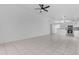Open-concept living space with a ceiling fan, tile floors, and access to the kitchen at 1405 E Chicago Cir, Chandler, AZ 85225