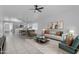 Open-concept living area with tile flooring, modern furnishings, and a seamless flow to the kitchen at 1405 E Chicago Cir, Chandler, AZ 85225