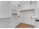 A bright walk-in closet features built-in shelving and wood rods at 1405 E Chicago Cir, Chandler, AZ 85225