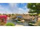 A picturesque community entrance sign and water feature with a stone waterfall and vibrant bougainvillea at 1405 E Chicago Cir, Chandler, AZ 85225