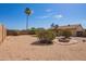Spacious backyard with desert landscaping, mature trees, and a charming fire pit at 1430 N Ashland --, Mesa, AZ 85203