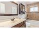 Updated bathroom with tiled shower, dark wood vanity, and neutral color scheme at 1430 N Ashland --, Mesa, AZ 85203
