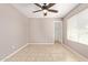 Neutral bedroom featuring a ceiling fan, tiled floors, and an open closet at 1430 N Ashland --, Mesa, AZ 85203