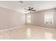 Bright, neutral bedroom featuring tiled floors, ceiling fan, and natural lighting at 1430 N Ashland --, Mesa, AZ 85203