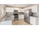 Modern kitchen with stainless steel appliances, tile flooring, and ample counter space at 1430 N Ashland --, Mesa, AZ 85203