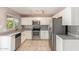 Bright kitchen with stainless steel appliances, tile flooring, and modern white cabinetry at 1430 N Ashland --, Mesa, AZ 85203