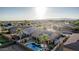 This aerial perspective shows a solar-paneled roof, private pool, desert landscaping, and mountain views at 16077 W Anasazi St, Goodyear, AZ 85338