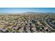 Expansive aerial view of a well-planned community, showcasing its numerous homes and mountain views at 16077 W Anasazi St, Goodyear, AZ 85338