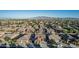 An aerial captures a well-planned community with lush landscaping, houses, and mountain views at 16077 W Anasazi St, Goodyear, AZ 85338