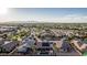 Scenic aerial view of a desert community featuring a solar paneled home with pool and mountain views at 16077 W Anasazi St, Goodyear, AZ 85338