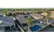 Aerial view features a fenced backyard with a pool, patio, fire pit, and solar panels at 16077 W Anasazi St, Goodyear, AZ 85338