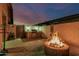 Outdoor kitchen and a cozy fire pit for evening gatherings make this backyard ideal for entertaining at 16077 W Anasazi St, Goodyear, AZ 85338