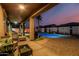 Backyard patio with luxurious seating surrounding a swimming pool at dusk at 16077 W Anasazi St, Goodyear, AZ 85338