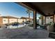 Backyard oasis featuring a sparkling pool with a waterfall feature and an extended covered patio at 16077 W Anasazi St, Goodyear, AZ 85338