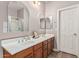 Bathroom features a double sink with white countertops and brown cabinets, and a glass enclosed shower at 16077 W Anasazi St, Goodyear, AZ 85338