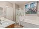 A tranquil bathroom boasts a double sink vanity, a shower, and a separate tub for a spa-like experience at 16077 W Anasazi St, Goodyear, AZ 85338