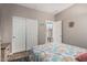 This bedroom has an ocean-themed comforter on the bed, a closet with sliding doors, and a bright window at 16077 W Anasazi St, Goodyear, AZ 85338