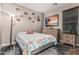 Comfortable bedroom features a coastal comforter, beach wall decor, and warm lighting to create a relaxing atmosphere at 16077 W Anasazi St, Goodyear, AZ 85338