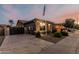 Charming single-story home featuring desert landscaping, gated RV parking, and a long driveway at 16077 W Anasazi St, Goodyear, AZ 85338