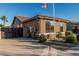 Inviting home exterior with desert landscaping, block wall, and tile roof under a clear blue sky at 16077 W Anasazi St, Goodyear, AZ 85338