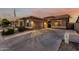 Lovely single-story home boasting desert landscaping, a spacious driveway, and a convenient two-car garage at 16077 W Anasazi St, Goodyear, AZ 85338