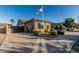 Charming single-story home boasts a tile roof, well-manicured landscaping, and an American flag at 16077 W Anasazi St, Goodyear, AZ 85338