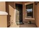 Inviting front porch with security door, charming decorations, and a convenient package delivery box at 16077 W Anasazi St, Goodyear, AZ 85338