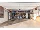 Large garage with many tools and storage containers, and a refrigerator against the back wall at 16077 W Anasazi St, Goodyear, AZ 85338