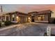 Attractive single-story home with garage, desert landscaping and a long driveway leading to the entrance at 16077 W Anasazi St, Goodyear, AZ 85338