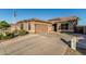 Charming home showcases a spacious garage, desert landscaping, and a classic tile roof at 16077 W Anasazi St, Goodyear, AZ 85338