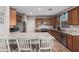 Beautiful kitchen featuring granite countertops, stainless steel appliances, and warm wood cabinetry at 16077 W Anasazi St, Goodyear, AZ 85338