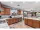An open kitchen features granite countertops, stainless steel appliances, and lots of wooden cabinetry for storage at 16077 W Anasazi St, Goodyear, AZ 85338