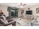 A cozy living room with a ceiling fan, recessed lighting, and a sliding glass door to a patio space at 16077 W Anasazi St, Goodyear, AZ 85338