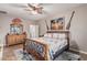 A light-filled main bedroom includes nautical decor, a ceiling fan, and ample space for a large bed and dressers at 16077 W Anasazi St, Goodyear, AZ 85338