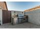 Built-in outdoor kitchen, featuring a stainless steel grill and ample counter space, perfect for outdoor cooking at 16077 W Anasazi St, Goodyear, AZ 85338