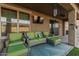 This covered patio with stylish seating offers a comfortable outdoor living space at 16077 W Anasazi St, Goodyear, AZ 85338