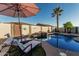Relax in this luxurious pool and spa surrounded by lush landscaping and a peaceful waterfall feature at 16077 W Anasazi St, Goodyear, AZ 85338