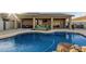 Sparkling pool with a rock feature and a spacious covered patio offers a serene outdoor retreat at 16077 W Anasazi St, Goodyear, AZ 85338