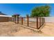 Fenced backyard area with lush landscaping, and wooden shade cover offers privacy and relaxation at 1676 W Sequoia Dr, Phoenix, AZ 85027