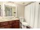 Standard bathroom featuring a vanity, toilet, and white shower curtain with a neutral color scheme at 1676 W Sequoia Dr, Phoenix, AZ 85027
