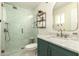 Beautiful bathroom featuring elegant white and green marble tiles, a new glass shower, and a mirror at 1676 W Sequoia Dr, Phoenix, AZ 85027